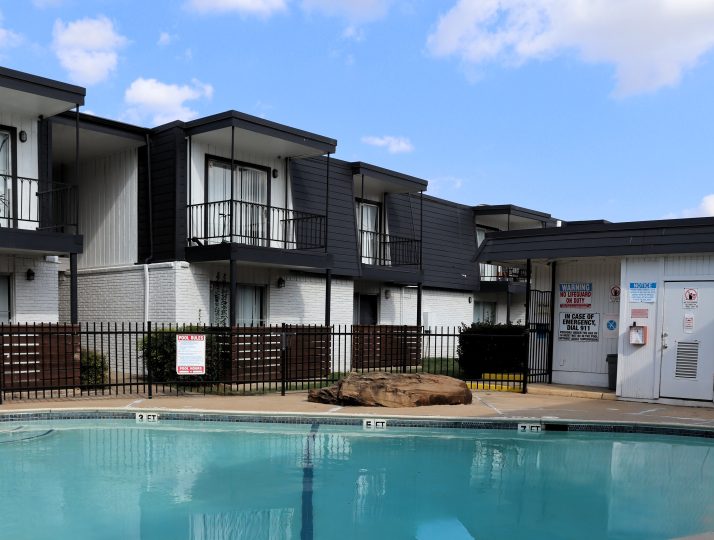 a large swimming pool in front of a house