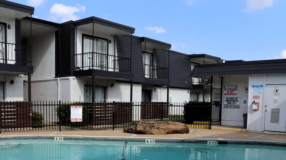 a large swimming pool in front of a house